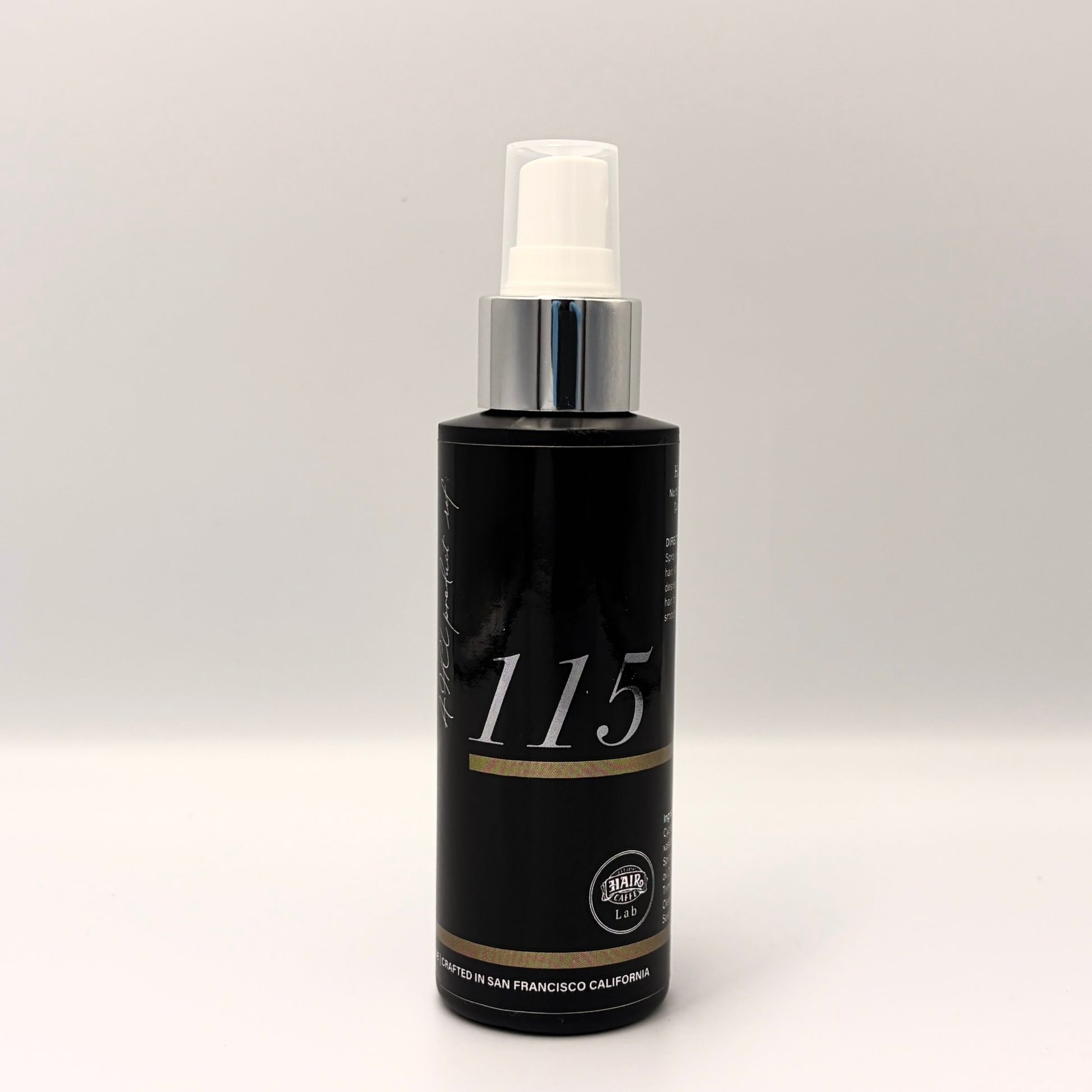 Hair Caffe Lab No.115 Leave-In Treatment Mist, black 4 fl oz spray bottle with silver collar and white 115 numerals, front view