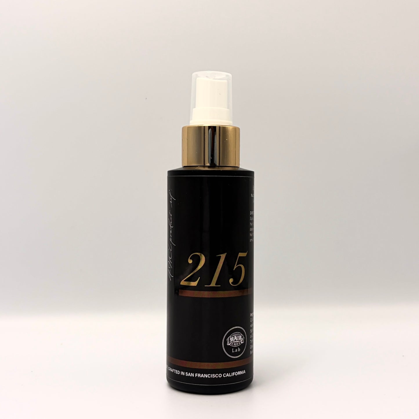 Hair Caffe Lab No.215 Leave-In Treatment Mist, black 4 fl oz spray bottle with gold collar and gold 215 numerals, front view