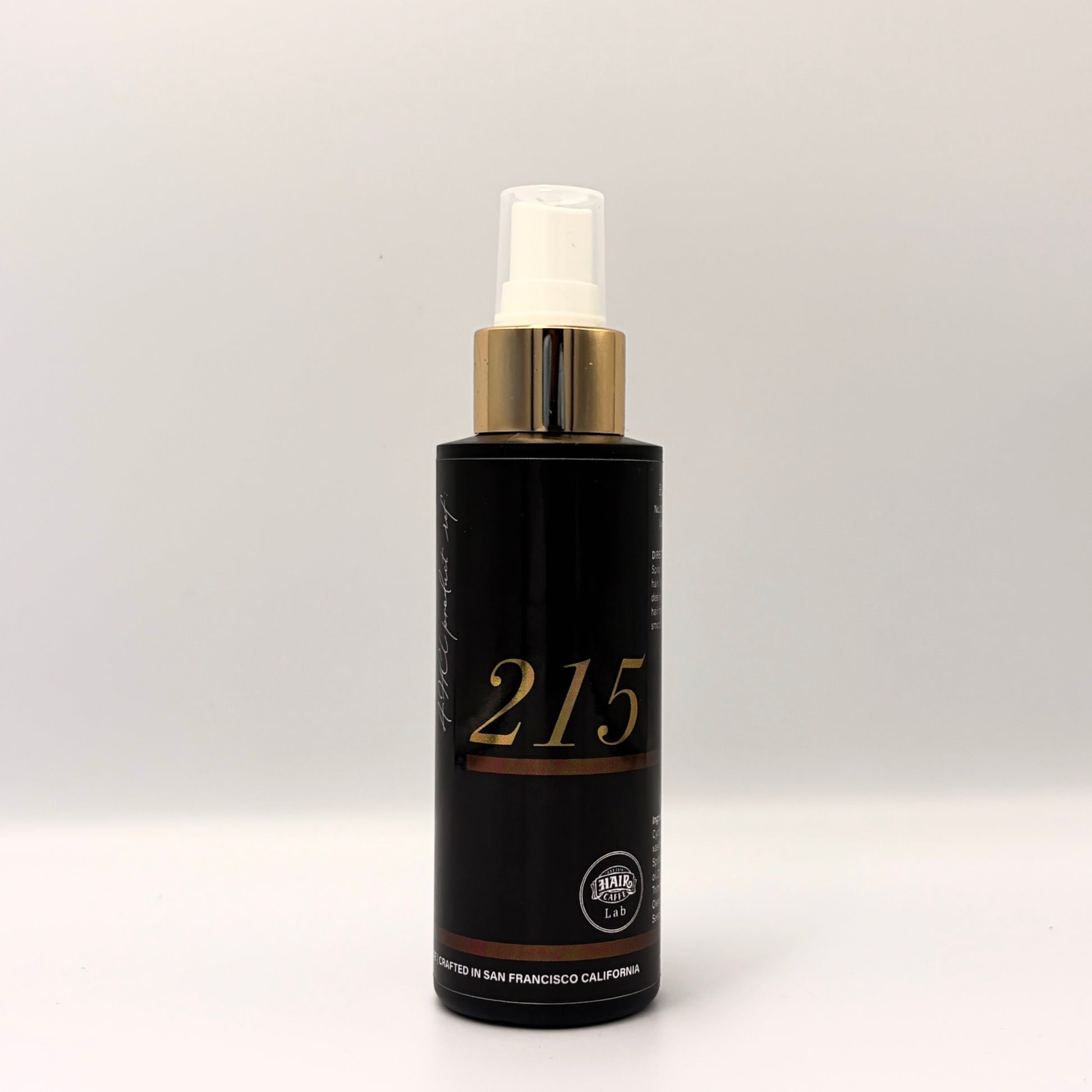 Hair Caffe Lab No.215 Leave-In Treatment Mist, black 4 fl oz spray bottle with gold collar and gold 215 numerals, front view