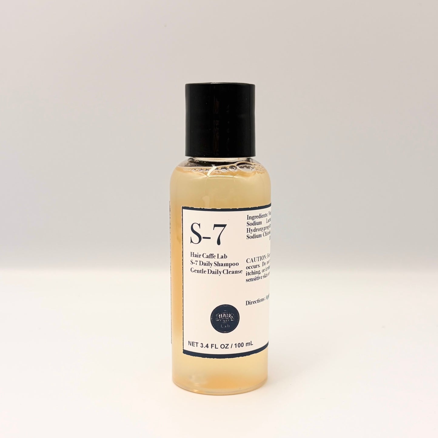 Hair Caffe Lab S-7 Daily Shampoo travel size, 3.4 fl oz / 100 mL clear bottle with black cap, front label