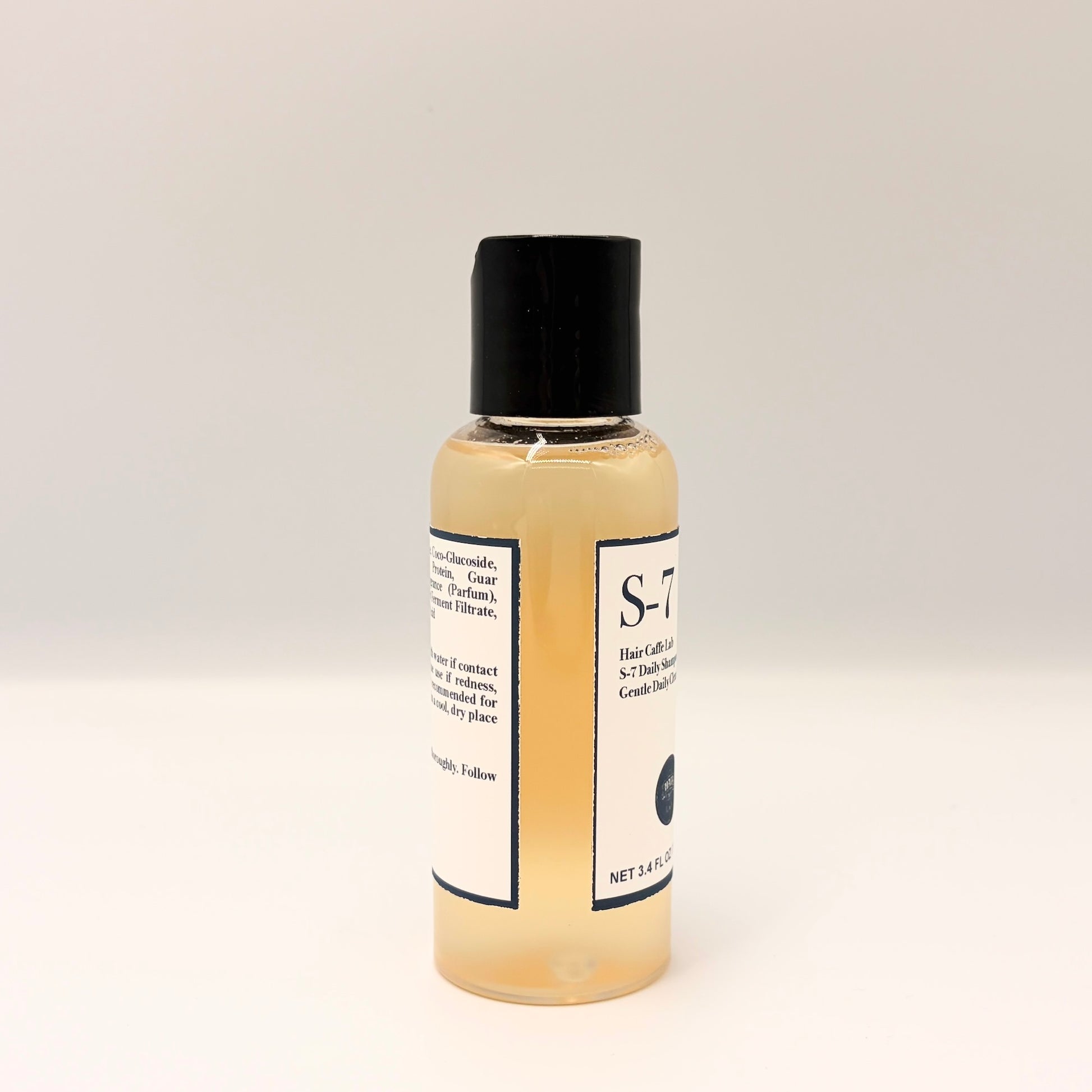 S-7 Daily Shampoo travel size bottle, angled view showing front and back labels