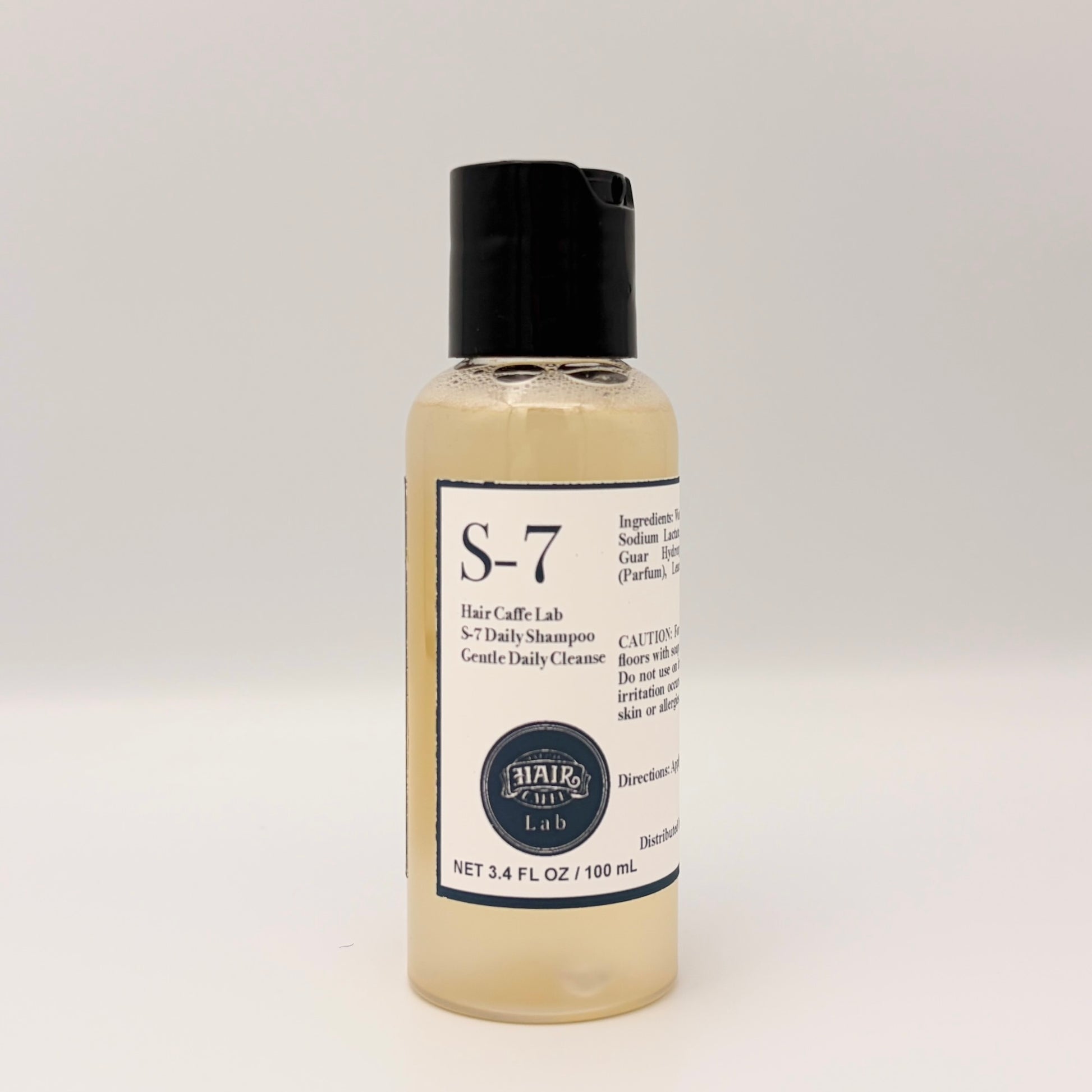 Hair Caffe Lab S-7 Daily Shampoo travel size, 3.4 fl oz / 100 mL clear bottle with black cap, front label